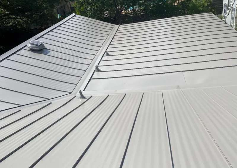 Solar attic fan installed on a metal roof for Roof Ventilation in Bridge City